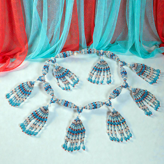Beaded necklace set on a light background with colorful fabric in the background