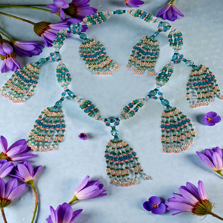 Beaded necklace with floral decorations on a light blue background