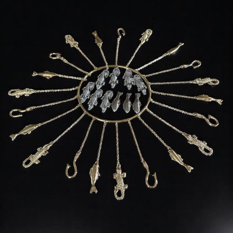 A handcrafted set of metal tools with a radiant brass-tone finish, hanging from a circular hoop, designed to represent the Orisha Olósa.