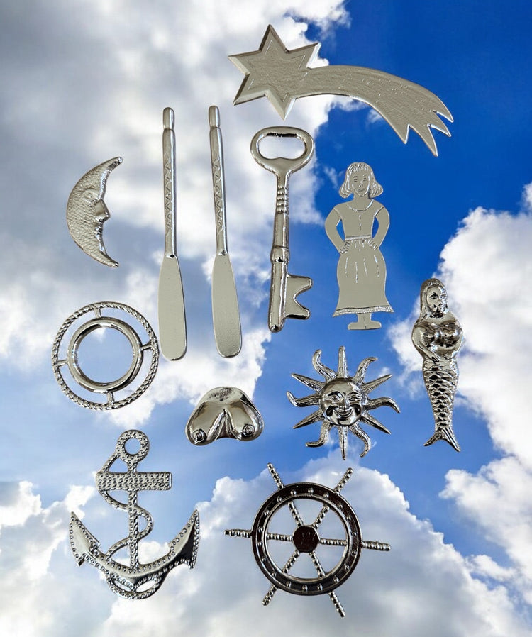 Collection of silver-colored metal tools for Yembo against a blue sky with clouds