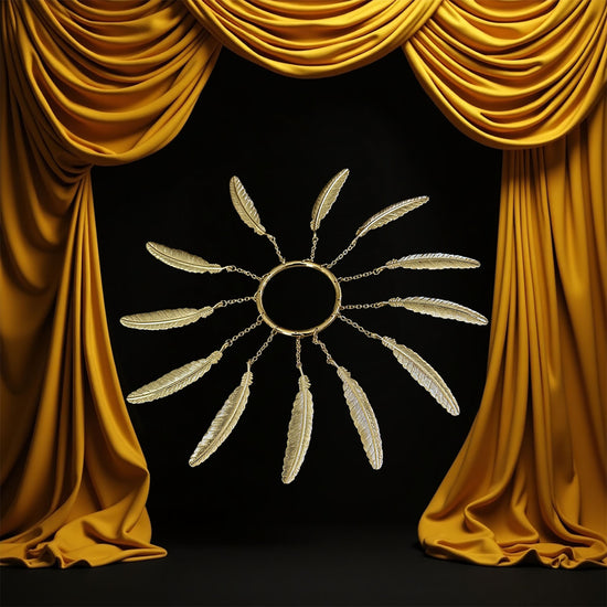 Brass Ring with 12 brass feathers on a black background with gold curtains.