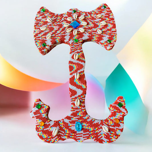 Colorful beaded double headed axe with shells and stones against a multi-colored background