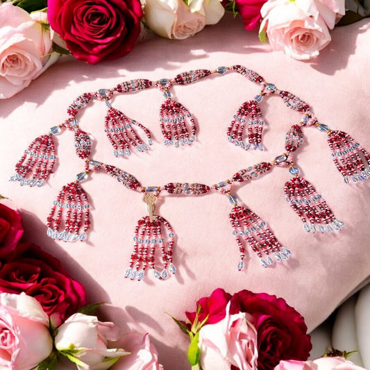 A detailed image of a necklace  adorned with intricate beadwork in shades of brown, pink, and red, featuring decorative keys as described in the product caption.