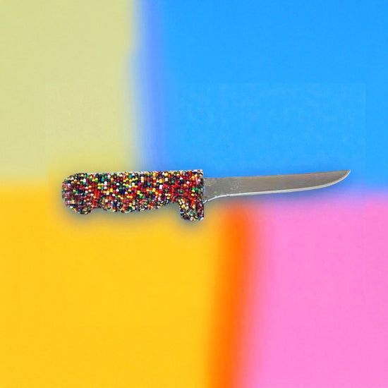 Knife with a colorful handle on a multicolored background