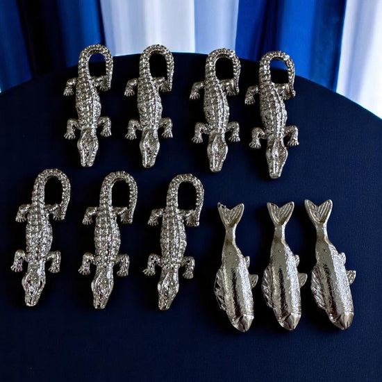 A handcrafted set of metal tools with a radiant brass-tone finish, , designed to represent the Orisha Olósa.