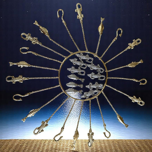 A handcrafted set of metal tools with a radiant brass-tone finish, hanging from a circular hoop, designed to represent the Orisha Olósa.
