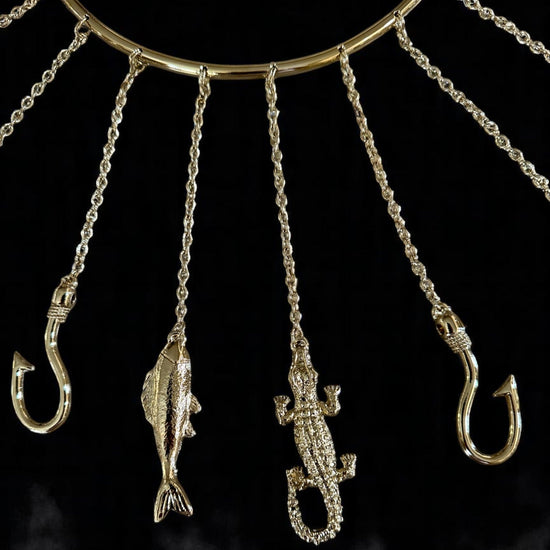 Close up of Olosa Tools with fishing hooks and fish shapes on a dark background
