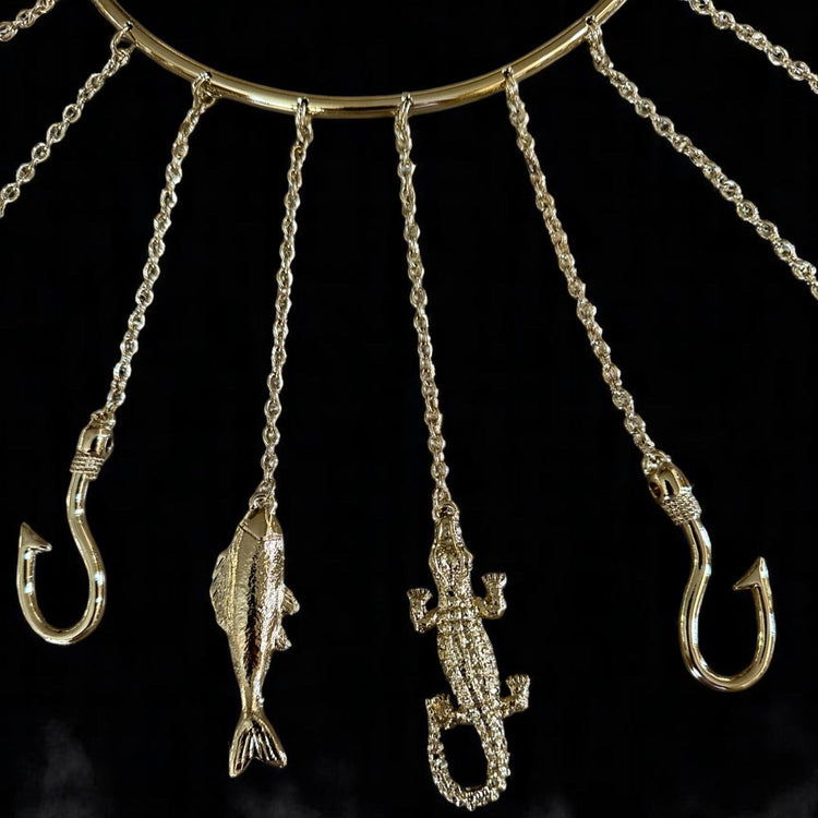 Close up of Olosa Tools with fishing hooks and fish shapes on a dark background
