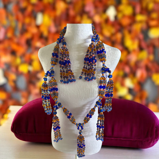 Beaded necklace on a mannequin with a colorful background.