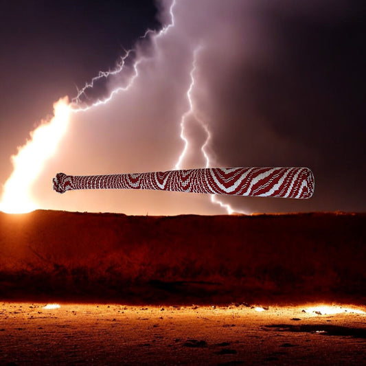 A handcrafted beaded war club with red and white beads and cowrie shells at the end, displayed against a stormy sky with lightning.