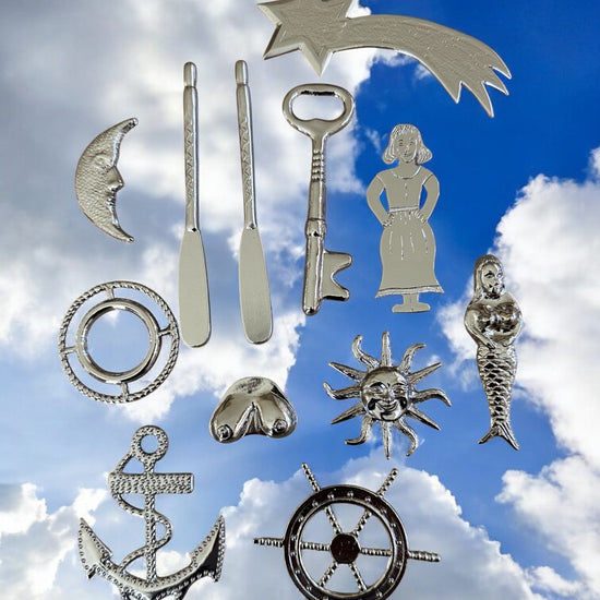 Collection of silver-colored metal tools for Yembo against a blue sky with clouds