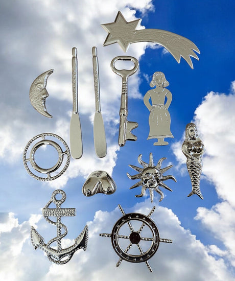 Collection of silver-colored metal tools for Yembo against a blue sky with clouds